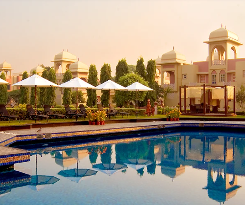 The poolside view of the Heritage Village Resorts and Spa, Manesar with the hotel in the backdrop.