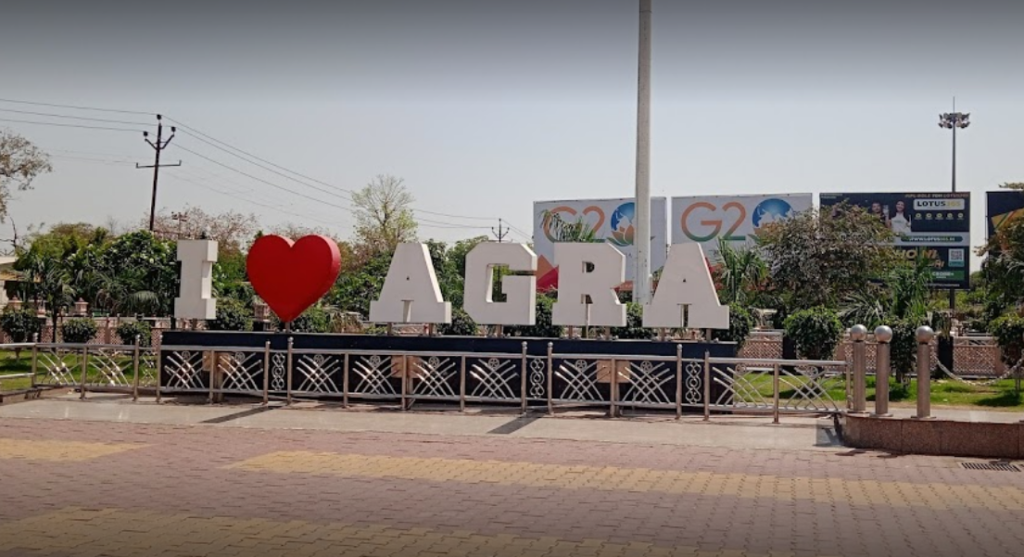 A road sigh that says 'I love Agra'.