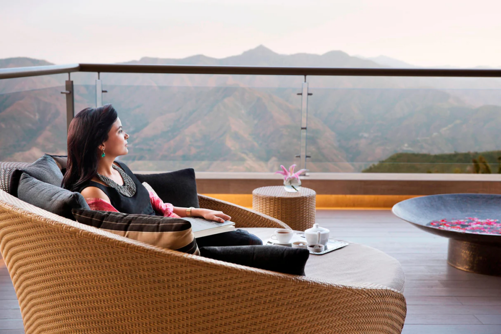 A woman relaxing and enjoying the mesmerizing view of the hills.